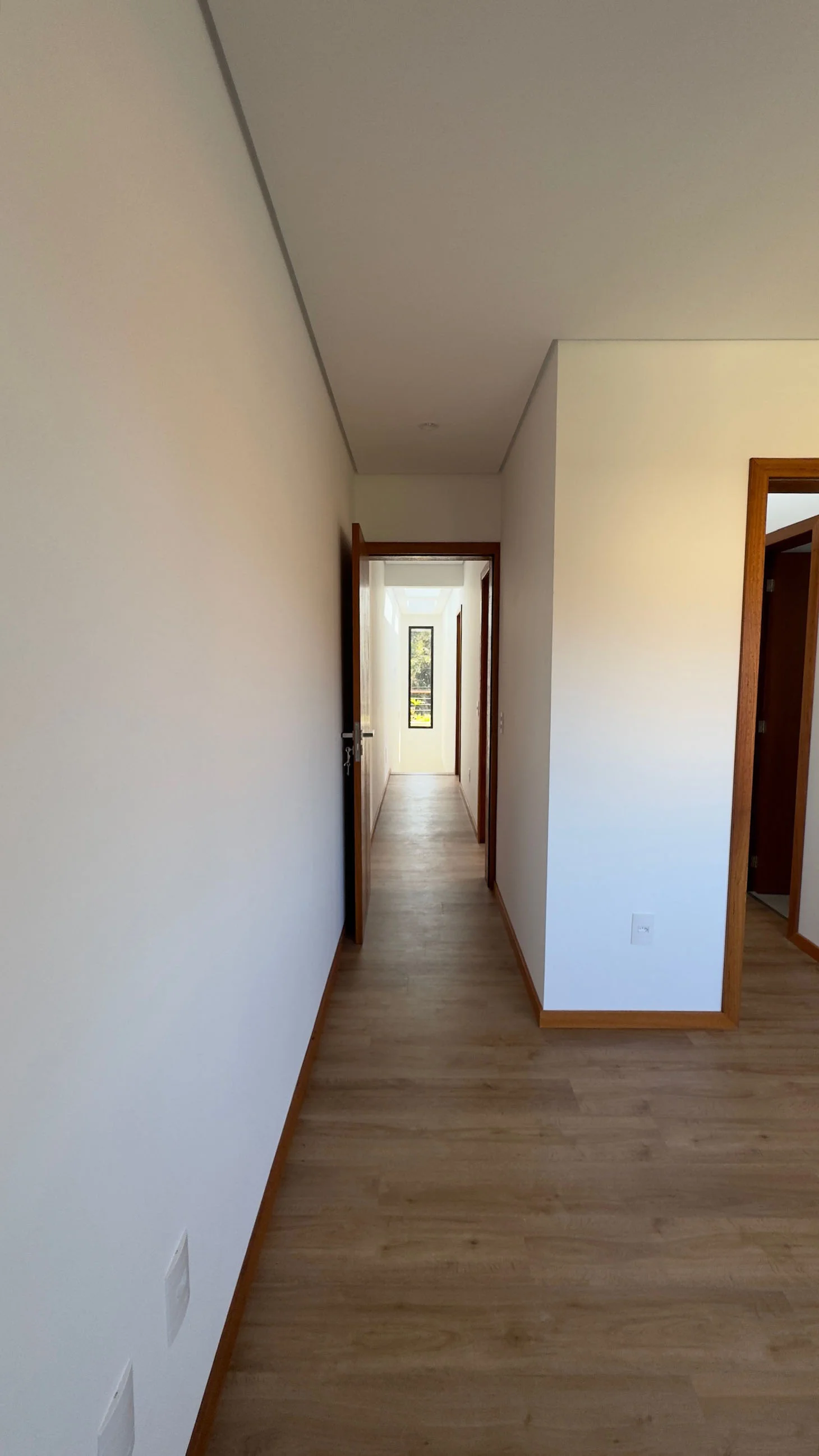 Bedroom doorway looking towards the open stair and its dark metal structure